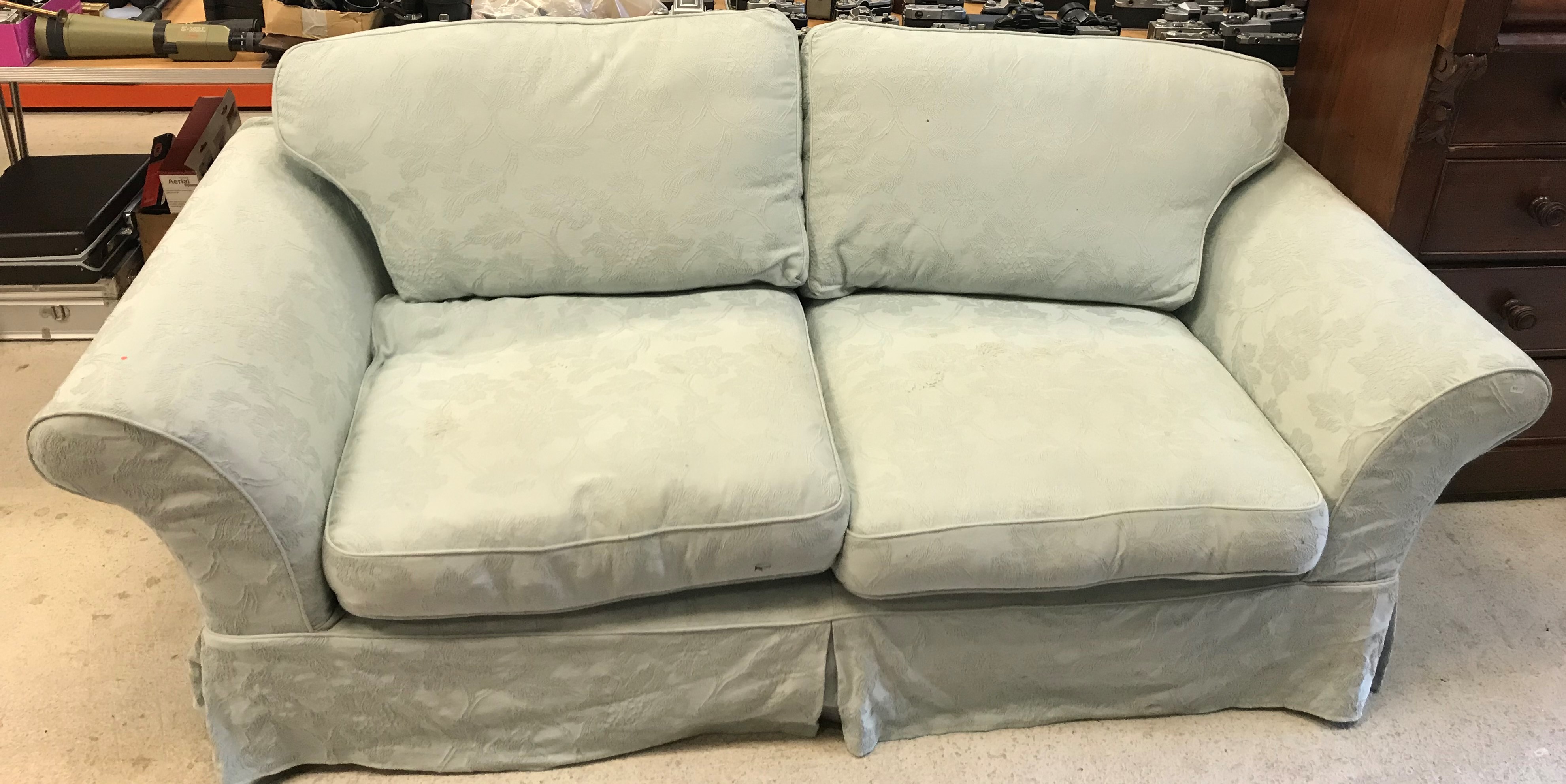 A modern upholstered scroll arm sofa with pale blue/green floral pattern loose covers 220 cm wide x