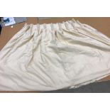 A pair of silk type cream interlined curtains with fixed triple pencil pleat headings,
