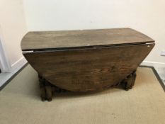 An oak oval double gate-leg drop-leaf dining table on barley-twist supports in the 17th Century