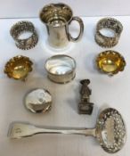 A collection of silver wares to include a small Christening jug of plain waisted form,