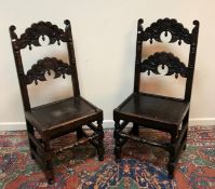 A pair of carved oak Yorkshire style panel seated hall chairs on turned legs to block feet united