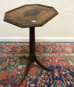 A mahogany single drawer side table in the George III manner raised on turned tapering legs to pad