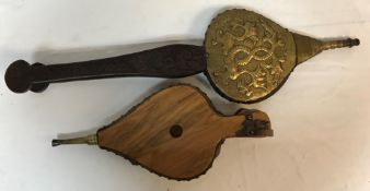 A pair of carved oak bellows with embossed sylised dolphin decoration, 77 cm long,