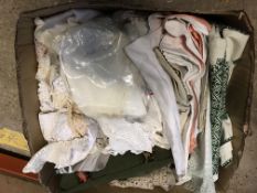 A box containing assorted table linens, lace trim, etc,