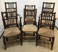 A set of six 19th Century ash rush seat spindle back dining chairs on turned legs to pad and ball