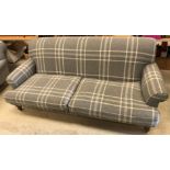 A modern grey check upholstered scroll arm sofa on turned and stained beech front legs 228 cm wide