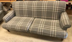 A modern grey check upholstered scroll arm sofa on turned and stained beech front legs 228 cm wide