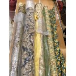 A collection of assorted part rolls / remnant rolls of upholstery fabric,