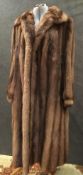 A ladies fur coat with chocolate brown satin lining