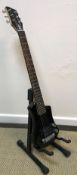 A Hofner "shorty" black bodied electric guitar and soft case