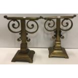 A pair of circa 1900 Christopher Dresser brass fire dogs of square form, with scrolling decoration,