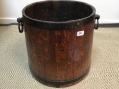 A Victorian coopered oak cask of tapered form with iron banding and handles (possibly for rum) 39