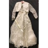 A mid 20th Century wedding / debutante dress in cream synthetic lace and matching bolero jacket and