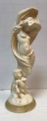 A simulated marble figure group of Venus and Cupid bearing label to underside "Stonelite made in