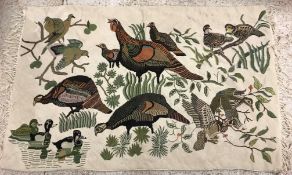 A 20th Century needlepoint rug / wall hanging decorated with pheasants, ducks, teal, widgeon, etc,