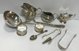 A collection of silver wares to include two early 20th Century silver milk / cream jugs,