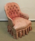 A Victorian upholstered scroll arm chair on turned front legs to castors 75 cm wide x 80 cm deep x