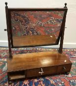 A Regency mahogany toilet mirror, the rectangular plate on square supports,