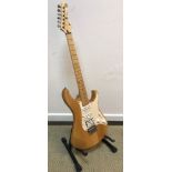 A Yamaha Pacifica strat copy guitar in natural wood body together with soft case
