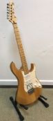 A Yamaha Pacifica strat copy guitar in natural wood body together with soft case