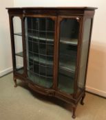 An Edwardian mahogany and inlaid display cabinet the single leaded glazed bow fronted door flanked