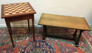 A modern mahogany and inlaid games top table with single frieze drawer on slender turned and ringed