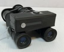 A Tasco 7x20 binocular camera (Field 508ft at 1000yrds No.