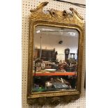 An early 18th Century English carved giltwood and gesso framed wall mirror with broken arch