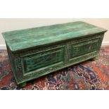 A modern Indian carved and green painted hardwood coffer, the plain top over two fielded panels,