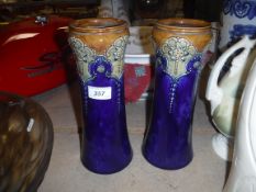 A pair of Royal Doulton blue ground floral decorated waisted vases in the Art Nouveau taste (No.