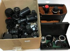 A collection of various camera lenses to include a Sigma DL Hyperzoom macro lens, Sigma zoom lens,