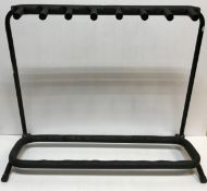 A free-standing seven section guitar stand,