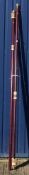 A pair of mahogany coloured runner curtain poles with brassed pineapple finials,