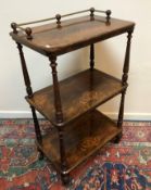 A Victorian burr walnut and marquetry inlaid three tier whatnot on turned and ringed supports to