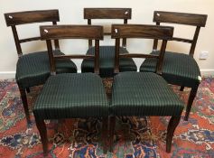 A set of five late Regency mahogany bar back dining chairs with moulded decoration and upholstered