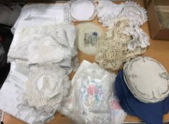 A box of assorted table linens to include place mats, tray cloths,