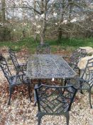 A modern wrought metal black painted and pierced garden table 155 cm x 96 cm x 70 cm together with