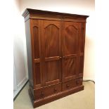 A modern mahogany double wardrobe with two drawer base 148 cm wide x 57 cm deep x 197.