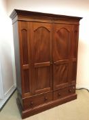 A modern mahogany double wardrobe with two drawer base 148 cm wide x 57 cm deep x 197.