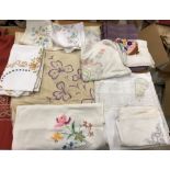 A box of assorted household linens to include tablecloths, serviettes,