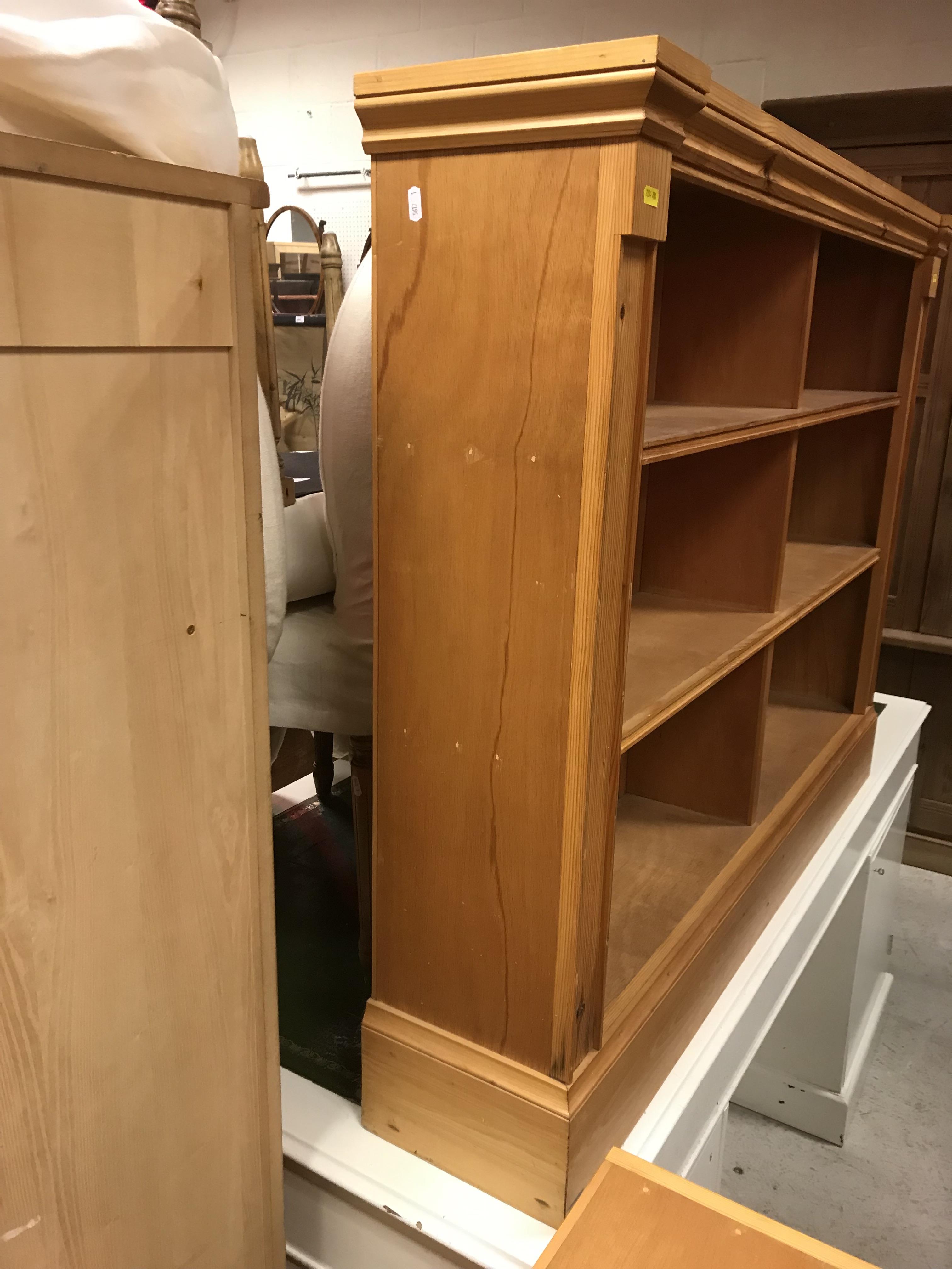 A pair of modern stained pine open bookcases of two banks of three shelves, raised on plinth bases, - Image 2 of 15