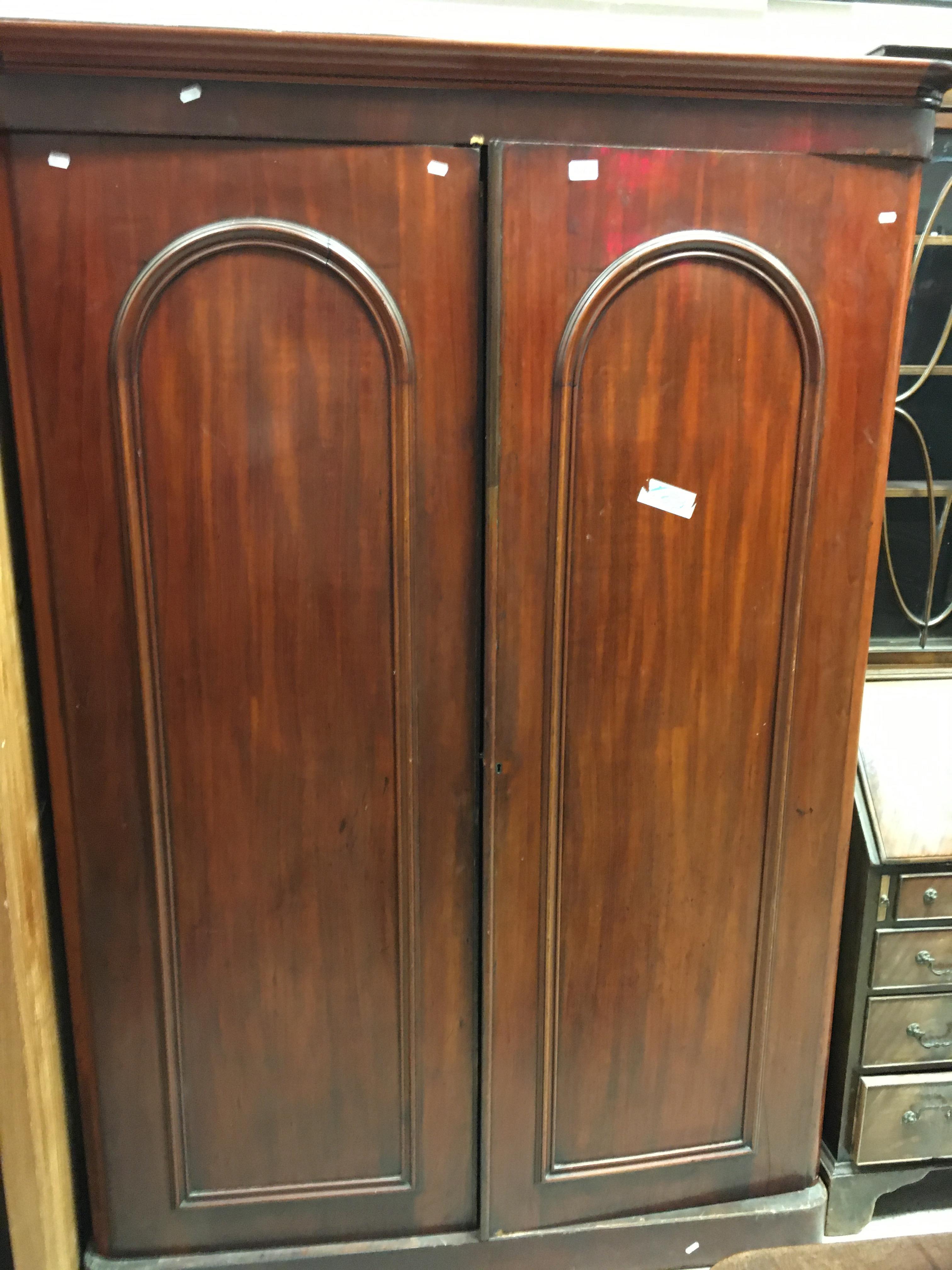 A Victorian mahogany two door wardrobe with hanging space over three drawers on a plinth base 135