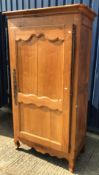 A 19th Century French chestnut armoire in the Provincial Louis XV taste with moulded cornice above