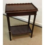 An early 20th Century mahogany two tier occasional table in the Georgian style,