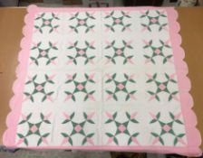 A 20th Century turkey tracks quilt in pink, white and green, with scalloped edge, 200 cm x 206 cm,