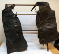 Two pairs of vintage leather chaps, both with studded decoration,