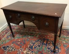 A mahogany dressing table in the Regency style, the top with moulded edge above a slim drawer,