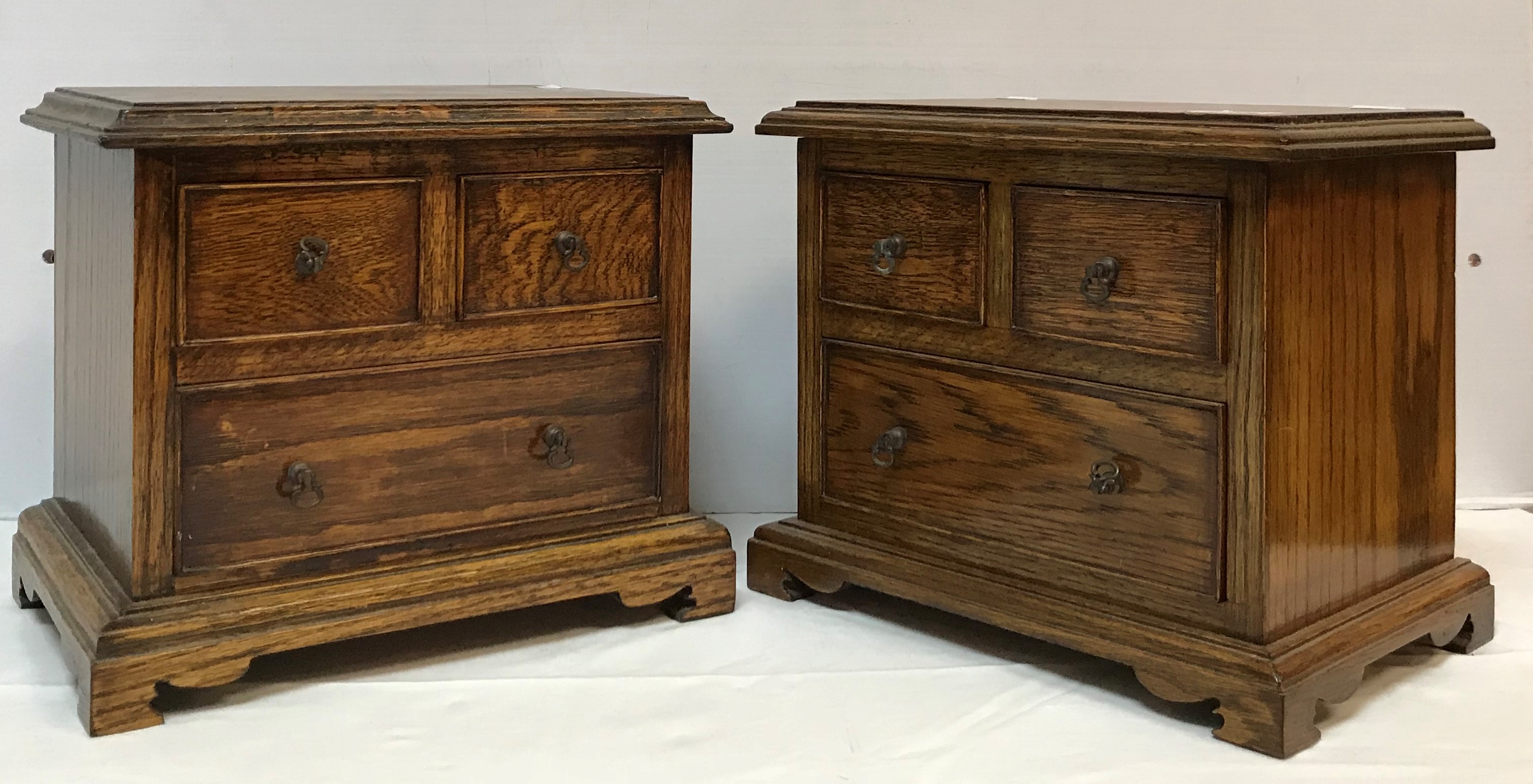 A 20th Century oak miniature table-top chest of two short over one long drawer,