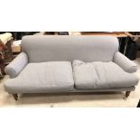 A modern pale grey upholstered scroll arm sofa on turned and stained beech front legs 228 cm wide x