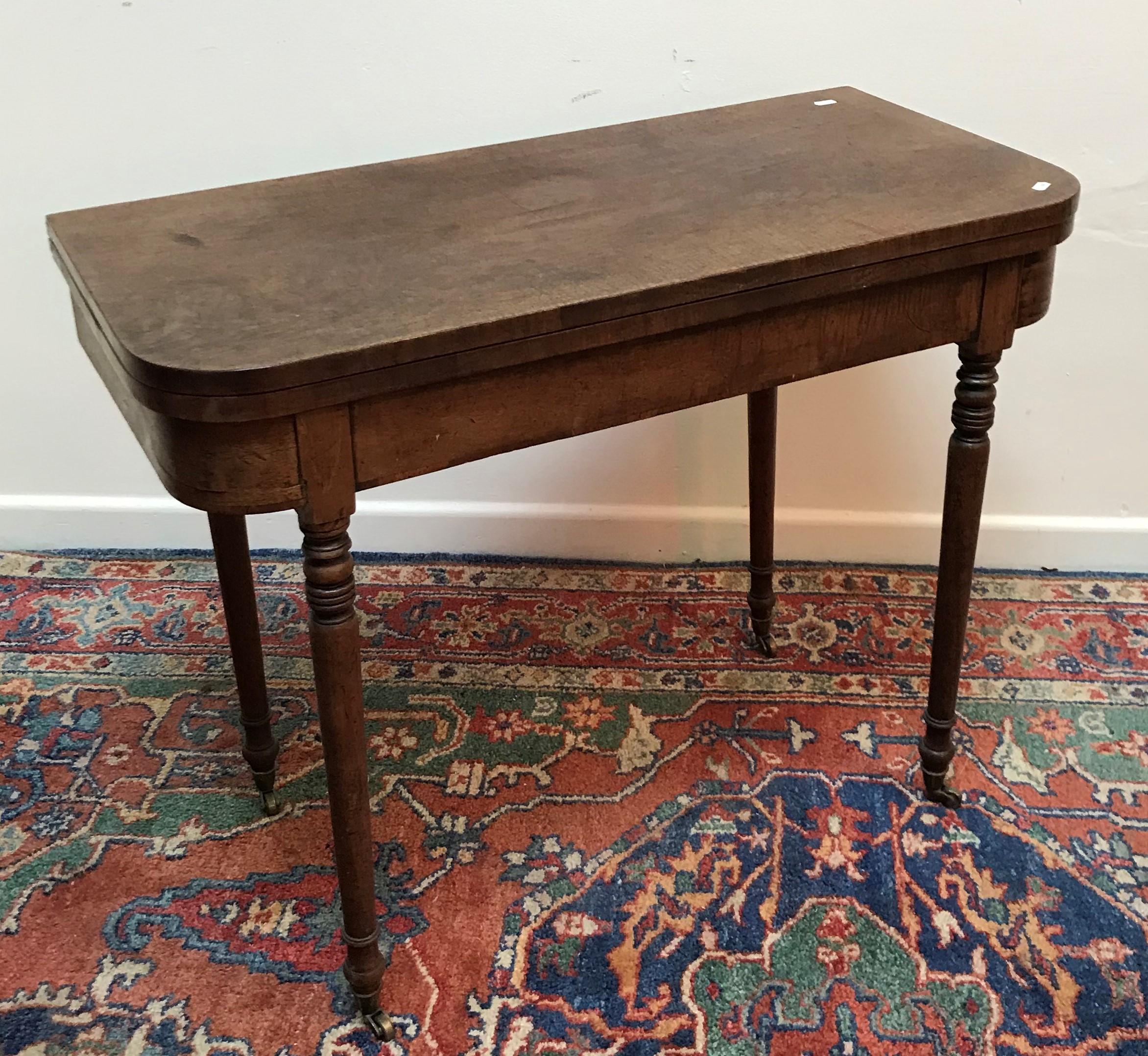 An early 19th Century mahogany foldover card table,